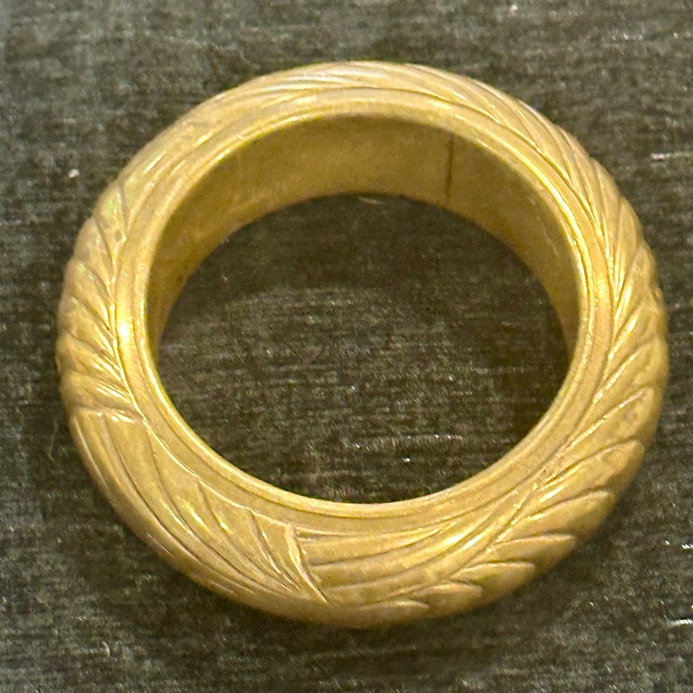 Antique gold bangle bracelet with raised graphic motifs, Art Nouveau style